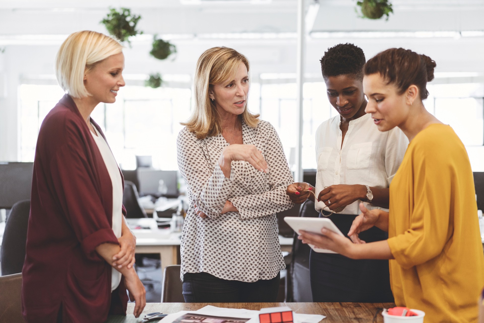 Multi-ethnic businesswomen discussing over tablet